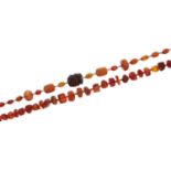 A necklace of amber and faturan beads, a necklace of vary shaped amber beads and a quantity of loose