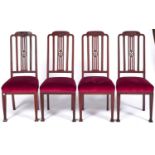 A set of four Edwardian mahogany dining chairs, c1910, the arched top rails carved to the centre