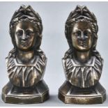 A pair of French bronzed iron chenet terminals modelled as the head of a classical woman, early 20th