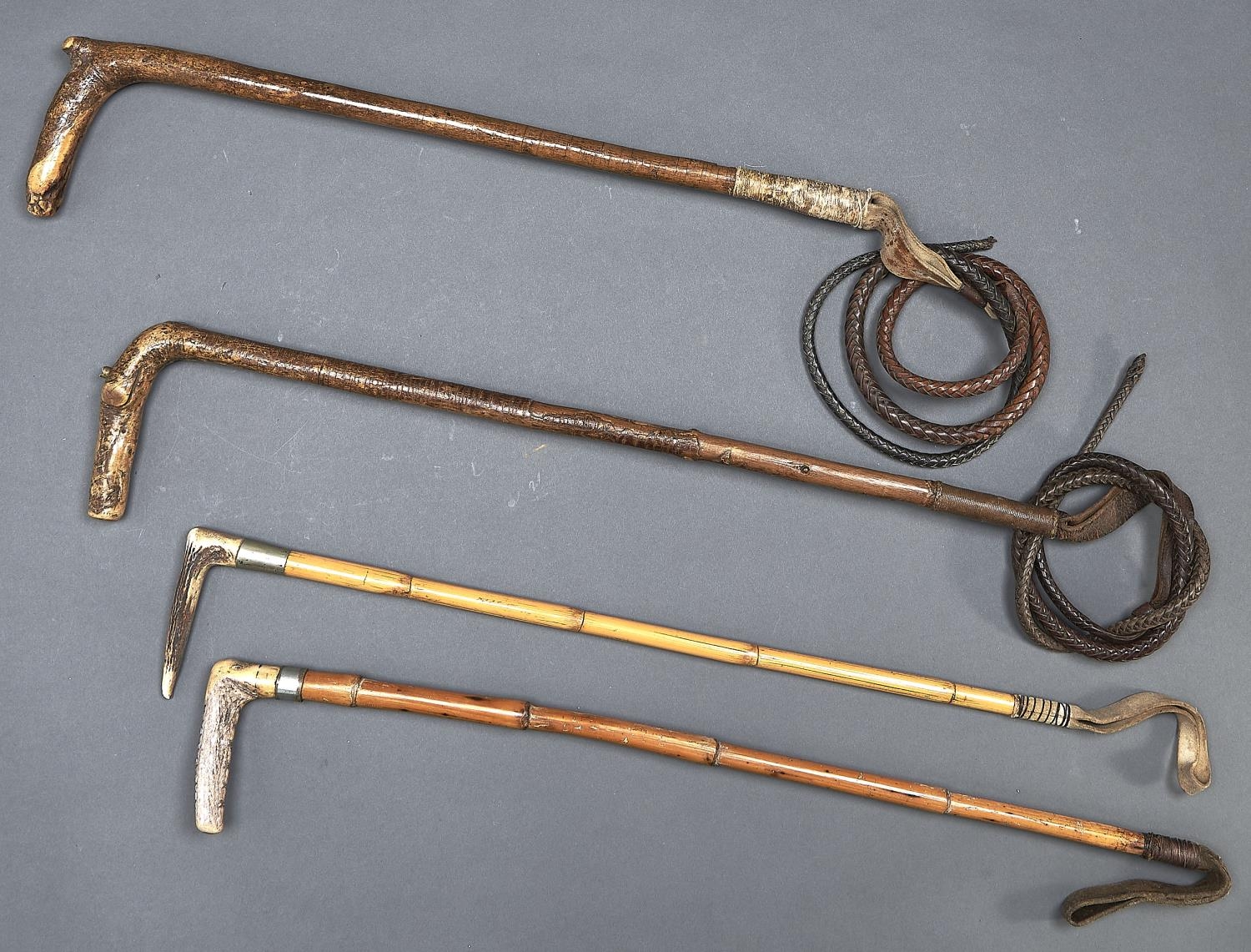 Two antler handled bamboo riding whips and two others, all late 19th/early 20th c,  one by