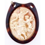 A cameo, the oval shell carved with Venus and putti, set in a tortoiseshell brooch