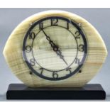 An Art Deco  onyx mantel clock, of flattened oval form, the onyx plate with pierced black