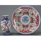 A Japanese Imari dish, Meiji period, with underglaze blue panelled diaper border, the underside