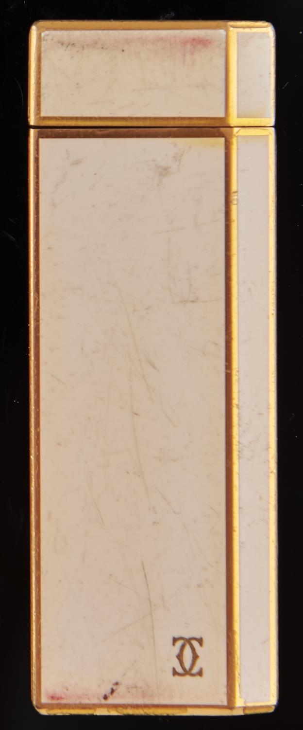 A Cartier cream lacquered and gold plated cigarette lighter, No 1C70714 Wear scratches consistent