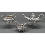 A Victorian silver melon shaped composed tea service, the teapot with realistic melon knop, on