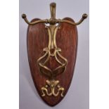 An art nouveau brass wall hanging dinner gong, on oak shield, 36cm h Good condition