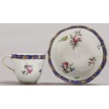 A Derby ogee coffee cup and saucer, c1780, painted with loose bouquets and scattered sprigs, the