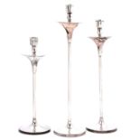 A set of three Elizabeth II silver candlesticks, of slender form, flared top and foot, by W I