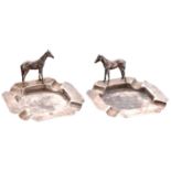 A pair of British Colonial silver ashtrays, set with a horse, c1930, control mark, SILVER and SAG,