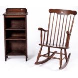 An oak open bookcase, early 20th c, 100cm h and a spindle back rocking chair (2) Old stains on the