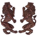 A pair of cast and bronzed metal reliefs of lions rampant, early 20th c, 74cm h, inscribed on the