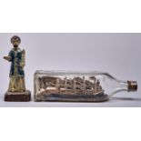 A partly painted wood, fabric and composition ship-in-a-bottle, late 19th c, 26.5cm l and a South