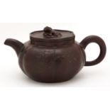 A Chinese Yixing teapot and cover,  the six lobed teapot carved with bamboo and calligraphy, the