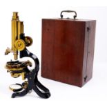 A brass compound microscope, J Swift & Son London,  the stand with Wale type pivot, focusing by rack