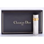 Christian Dior. A  silver and gold plated cigarette lighter, cased Practically as new