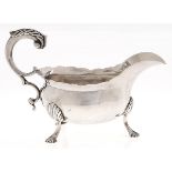 A George III silver sauce boat, with leaf capped flying scroll handle, on three hoof feet, 14.5cm l,
