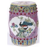 A Chinese pink ground famille rose garden seat, 20th c, enamelled with panels of peafowl and bird on