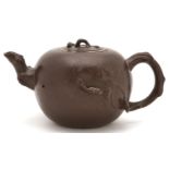 A Chinese Yixing stoneware teapot, cover and infuser,   globular with foliage and branch issuing