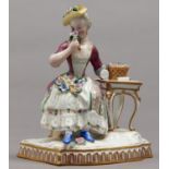 A Meissen figure of a lady from a set of The Five  Senses, as the personification of Smell,