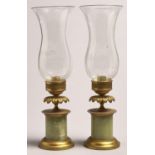 A pair of gilt brass mounted onyx candlesticks and glass shades, 20th c, in Empire style, 38cm h