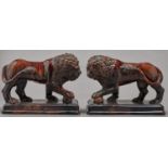 A pair of British treacle brown glazed earthenware models of the Medici lion, mid 19th c, 21cm h One