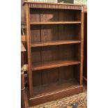 An oak bookcase, c1950, the rectangular top above fluted frieze, three adjustable shelves,