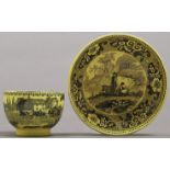 An English yellow glazed earthenware tea bowl and contemporary saucer, early 19th c, with black or