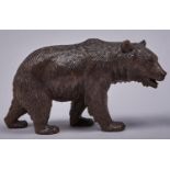 A Swiss stained limewood carving of a bear, early 20th c, black button eyes, 11cm h A good