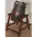 An oak, ash and iron butter churn, late 19th c, on pine stand, 76cm h Complete and in good