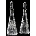 A pair of EPNS mounted conical glass decanters and stoppers, engraved with Bellerophon and putti,