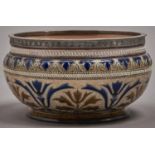 A Doulton ware salad bowl, 1883, decorated by George Hugh Tabor with bands of stylised foliage and