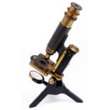 A brass and black painted steel compound microscope, c1900, the limb on trunnions with fine