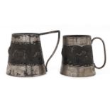 Two similar graduated South East Asian silver repousse mugs, decorated with a central band of wild