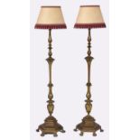 A pair of good quality brass candlestick form standard lamps, on hexagonal base and six paw feet,