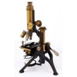 A brass compound microscope, Baker 244 High Holborn, London, c1900, the bar limb between trunnions