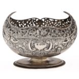 An Edwardian silver boat shaped bowl, stamped with foliage and c-scrolls beneath pierced border,