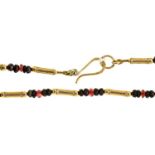 A 9ct gold necklace, with faceted ruby and other beads at intervals, 15.5g Good condition