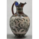 A Doulton ware ewer, c1900, decorated by Eliza Simmance, with a wide band of flowers and foliage,