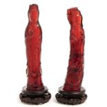 A pair of Chinese red phenolic resin statuettes of Guanyin, 20th c, affixed wood stands, 33cm h Good