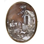 A  cameo brooch, the oval shell carved with a village scene, gold mount, marked 9ct, 20g Good