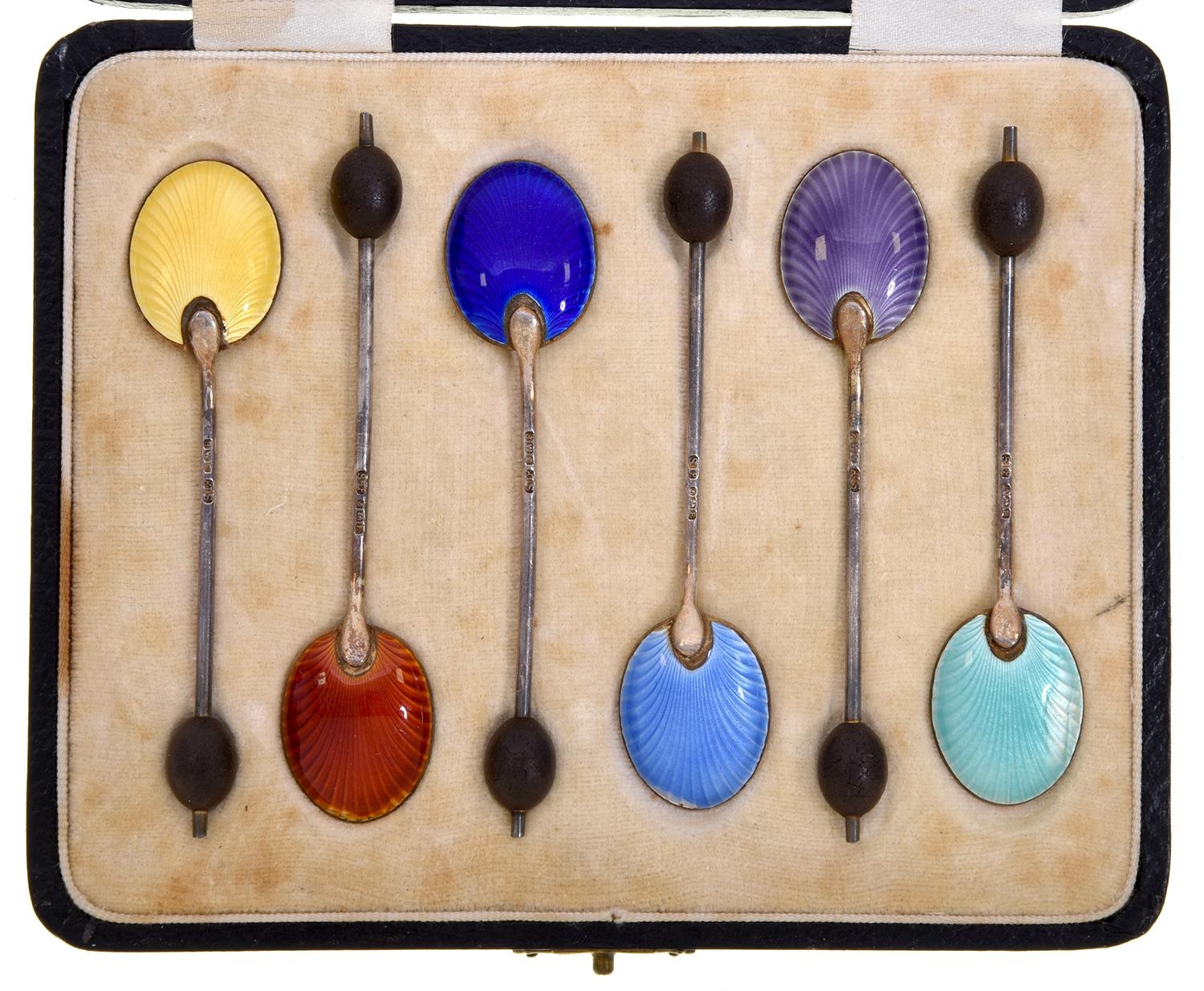 A set of six George V silver gilt and harlequin guilloche enamel coffee spoons, Birmingham 1930,