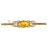 An amber bar brooch,  in 9ct gold, 2.6g Good condition