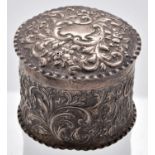 A Victorian silver cylindrical box and cover, die stamped with scrolling foliage, by C S Harris,