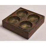 An oak change tray with four brass coin wells, 19th / 20th c, 20 x 20cm Old ink stains and