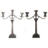 A pair of George V silver columnar candelabra of three light, with Corinthian capitals, beaded