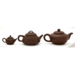 Two Chinese Yixing stoneware teapots and covers and a miniature example, 90mm h and smaller Good