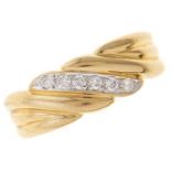 A diamond wrythen fluted 18ct gold band, import marked London 1989, 3.4G, size K½ Good condition