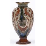 A  Doulton ware vase, 1904, decorated by Frank A Butler with stylised foliage outlined with beads,