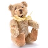 A Steiff miniature teddy bear, c1930's, of pale golden mohair with brown stitched snout Bald patch