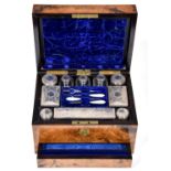 A Victorian silver-fitted walnut dressing case, lined in blue velvet and watered silk, retaining the